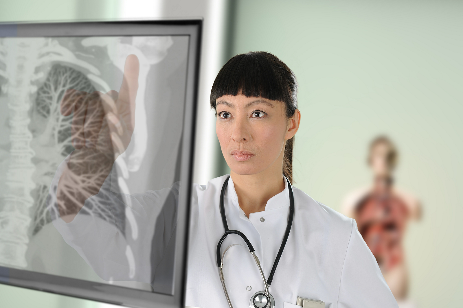 A doctor scrutinizes a chest image on a touchscreen display